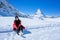 Young Woman Tourists playing snow in mountain Matterhorn peak, Zermatt, Switzerland