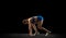 Young woman, track athlete training  over black studio background.