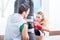 Young woman with trainer in boxing sparring