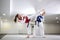 Young woman training martial art of taekwondo with her coach