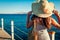 Young woman traveler admiring sea landscape on pier by Red sea. Summer vacation