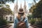 Young woman traveler with backpack and hat looking at the church in the city, Female tourist sightseeing at St Joseph\\\'s