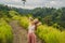 Young woman traveler in Campuhan Ridge Walk , Scenic Green Valley in Ubud Bali