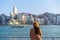 Young woman traveler enjoying the sunset atmosphere at Victoria harbour in Hong Kong