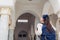 Young woman traveler going sightseeing in Egypt. Girl walking on excursion looking at Al Salam mosque