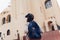 Young woman traveler going sightseeing in Egypt. Girl walking on excursion looking at Coptic church
