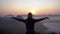 Young woman traveler looking at sea of mist and sunset over the mountain