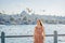 Young woman traveler in pinc dress enjoying great view of the Bosphorus and lots of seagulls in Istanbul