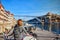 Young woman traveler standing back enjoying beautiful cityscape view on Douro river, bridge and boats during the morning light in