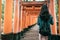 Young woman traveler walking in torii