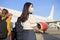 Young woman traveler wearing protective mask getting in airplane and ready to take off, travel under Covid-19 pandemic, safety