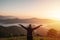 Young woman travelers looking at the sunrise and the sea of mist on the mountain in the morning, Travel lifestyle concept