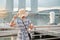 Young Woman traveling with hat in the morning, happy Asian traveler visit in Singapore city downtown. landmark and popular for