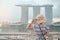 Young Woman traveling with hat in the morning, happy Asian traveler visit in Singapore city downtown. landmark and popular for