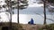 A young woman traveller sitting by the Norwegian fjord