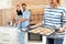 Young woman treating her family with homemade oven baked cookies