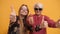 Young woman and trendy granny with sunglasses holding thumbs up. Studio shot