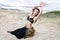 Young woman tribal american style dancer. Girl dancing and posing on the beach sand wearing belly dance costume. Ethnic