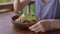 A young woman in a tropical cafe eat healthy vegetarian salad. Vegan food concept. Slowmotion shot