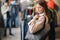 Young woman trying on black bag. Woman in boutique