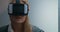 Young woman is trying on virtual reality glasses