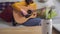 Young woman tunes guitar on the table is ultrasonic humidifier