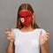 Young woman with Tunis flag painted on her face