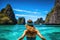 Young woman in turquoise water at Maya bay, Phi Phi island, Thailand, A young woman swimming in clear sea water in a lagoon and