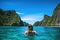 Young woman in turquoise water on Phi Phi island, Thailand, Young woman swimming in clear sea water in lagoon and looking at