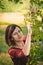 Young woman with twig of mulberry