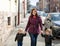 Young woman and two little boys walking through spring city