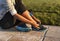 Young woman tying shoelace of sneakers to make outwork training running. Fitness and healthy lifestyle