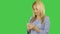 Young woman typing text message on smart phone at green screen. Young woman stands and using mobile phone. Alpha channel