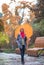 Young woman with umbrella in beautiful autumn park.