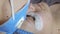 Young woman undergoing eyelash extensions procedure, closeup