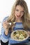 Young Woman Unhappy Eating Mixed Vegetables