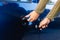 Young woman unlocking her blue car door with key in hand.