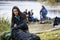 Young Woman Unpacking Backpack At Campsite