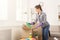 Young woman unpacking boxes after moving