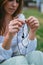 Young woman untangling earphones wire