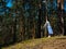 A young woman unwraps a bright yoga Mat in the forest, copy space, Sunny weather, summer. The girl is preparing for practice and