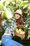 Young woman up on a ladder picking apples from an apple tree on a lovely sunny summer day