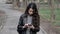 Young woman use mobile phone, reading news on mobile phone walking in Park in city