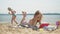 Young woman uses computer tablet on the beach, river bank