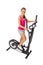 Young woman uses elliptical cross trainer.