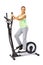 Young woman uses elliptical cross trainer.