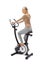 Young woman uses stationary bicycle trainer.