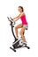 Young woman uses stationary bicycle trainer.