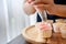 Young woman using cream squeeze bag to decorating the cupcake, making cupcake