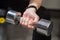 Young woman using dumbbell